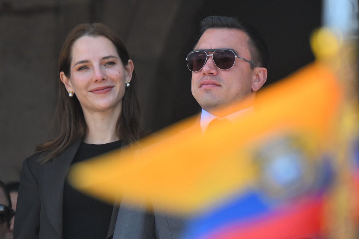 Photo used for representational purposes. Ecuador's reelected President Daniel Noboa (R) and his wife, Lavinia Valbonesi, gesture from a balcony of the Carondelet Presidential Palace during the changing of the guard ceremony in Quito on April 15, 2025. Photo by Rodrigo BUENDIA / AFP.