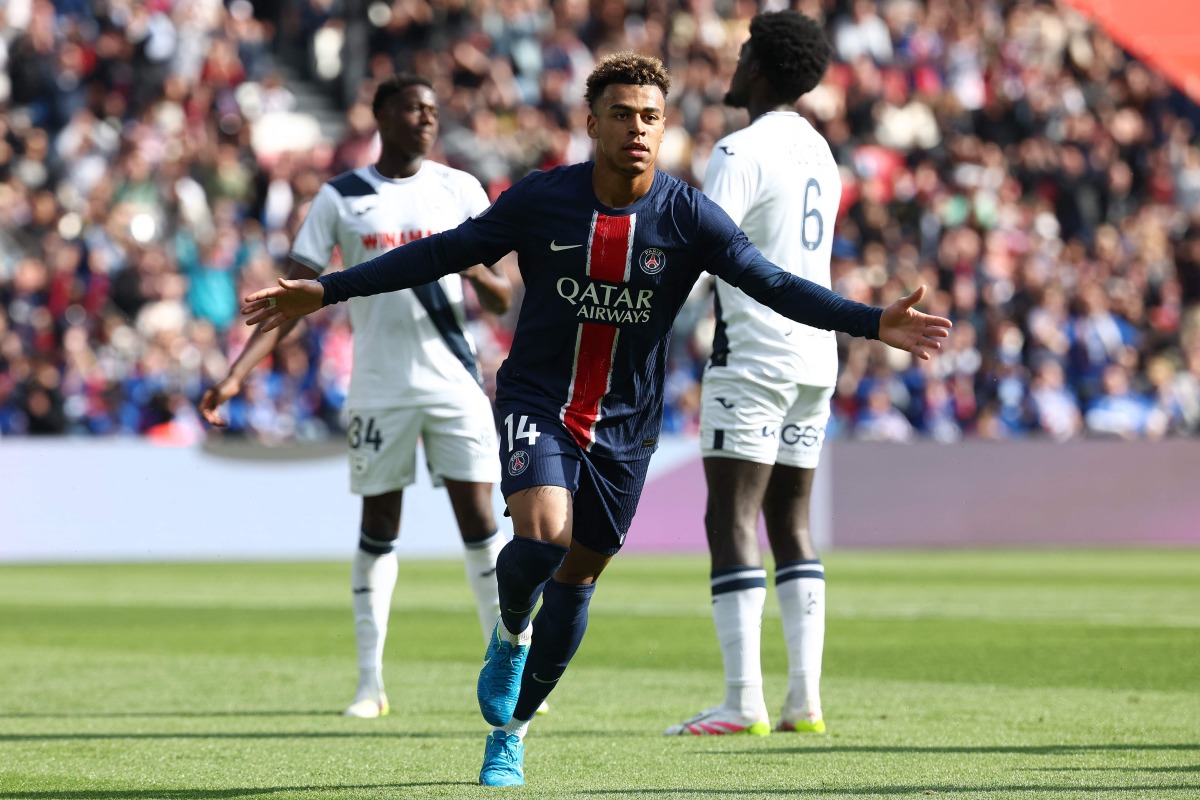 Paris Saint-Germain's French midfielder #14 Desire Doue celebrates after scoring PSG's first goal during the French L1 football match between Paris Saint-Germain (PSG) and Le Havre AC at the Parc des Princes Stadium in Paris on April 19, 2025. (Photo by FRANCK FIFE / AFP)
