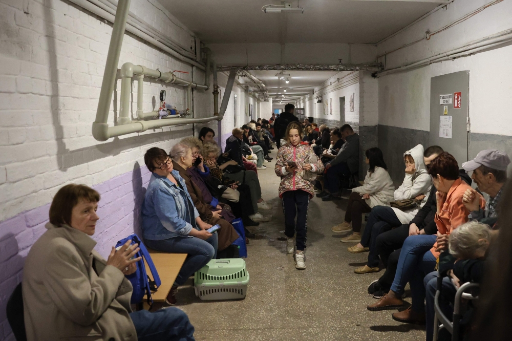 Local residents take cover in an underground shelter during a Russian missile attack in Kyiv early on April 24, 2025. (Photo by Stringer / AFP)