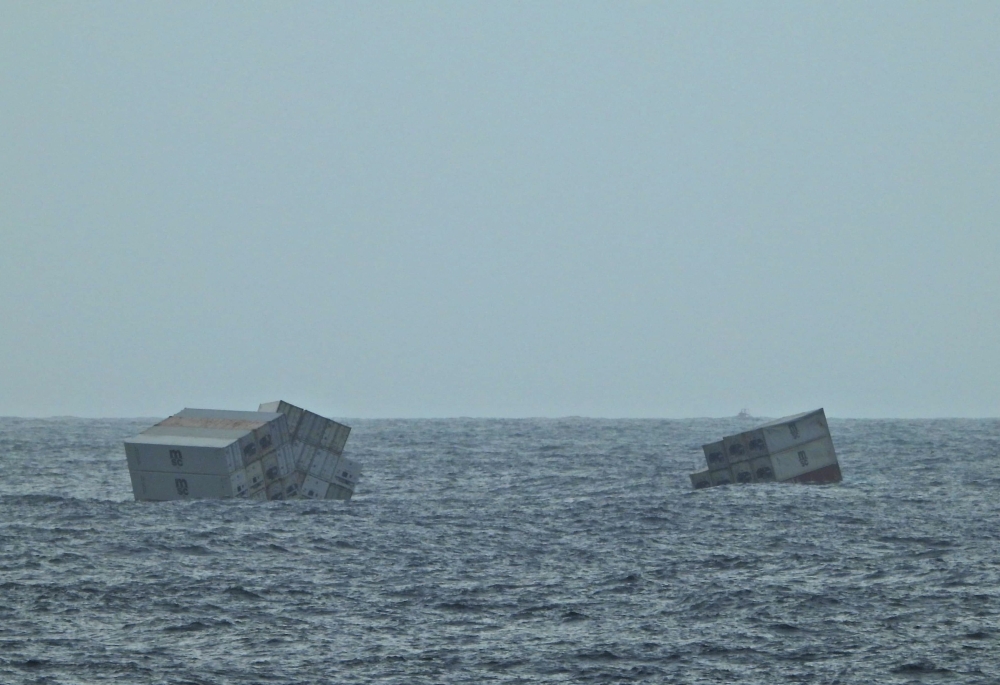 This photograph taken and released on May 25, 2025 by the Indian Defence Public Relations Office (PRO) of Mumbai, shows Liberian-flagged ship's containers after it capsized off India's southern coast of Kerala. (Photo by Indian Defence Public Relations Office (PRO) of Mumbai / AFP) 