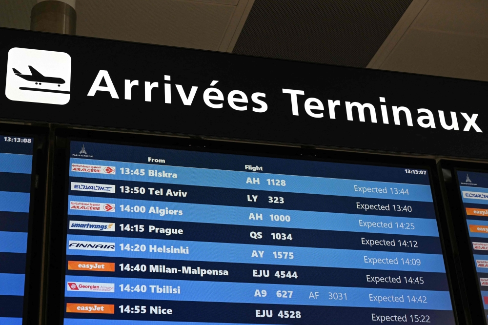 This photograph shows a board listing arriving flights at Roissy-Charles de Gaulle Airport north-east of Paris on June 10, 2025, as Swedish campaigner Greta Thunberg left Israel on a flight to Sweden via France, after she was detained along with other activists aboard a Gaza-bound aid boat. (Photo by Hugo Mathy / AFP)