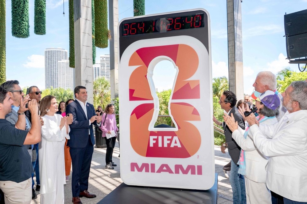 Beau Ferrari and Marc Anthony unveil the FIFA World Cup Miami Countdown Clock during the FIFA World Cup One Year Out Celebration at Perez Art Museum Miami on June 11, 2025 in Miami, Florida. (Photo by Ivan Apfel/Getty Images via AFP)