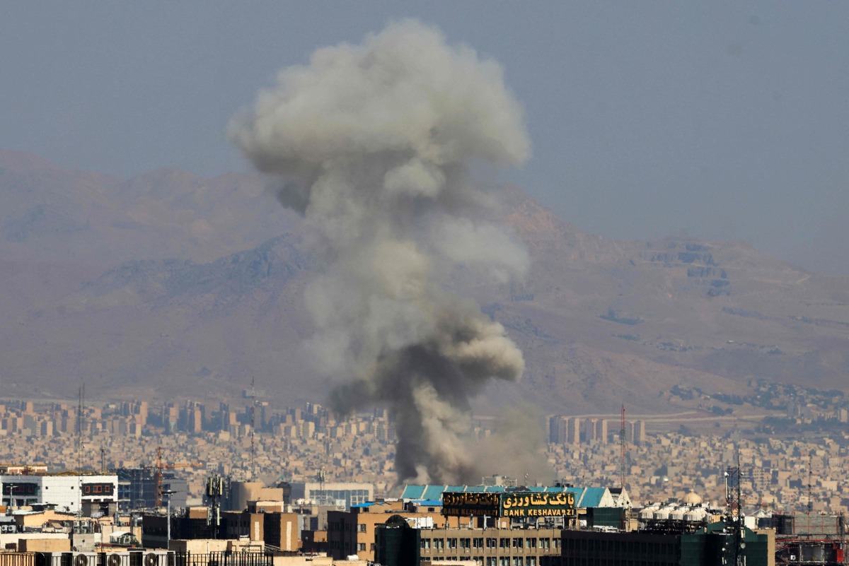 moke billows following an explosion in central Tehran on June 15, 2025. Iranian media said an Israeli strike hit the Tehran police headquarters in the city centre on June 15, as the two foes exchanged fire for a third day. (Photo by Atta KENARE / AFP)