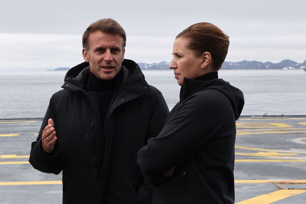 French President Emmanuel Macron (left) and Denmark's Prime Minister Mette Frederiksen aboard the Danish frigate F363 Niels Juel in Nuuk, Greenland, on June 15, 2025. (Photo by Ludovic Marin / AFP)
