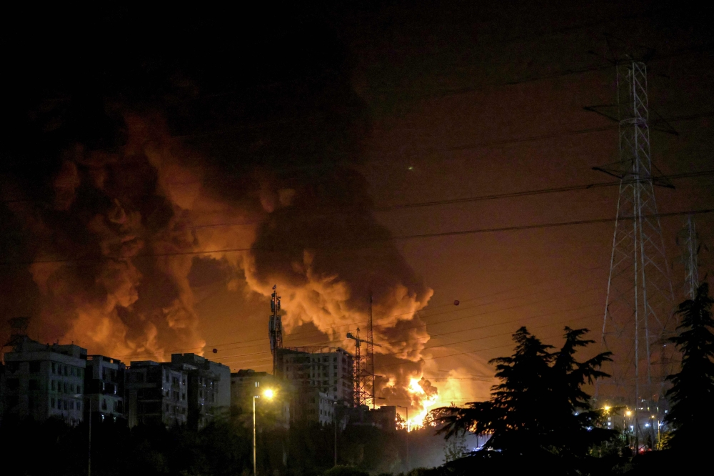 A fire blazes in the oil depots of Shahran, northwest of Tehran, on June 15, 2025. (Photo by Atta Kenare / AFP)