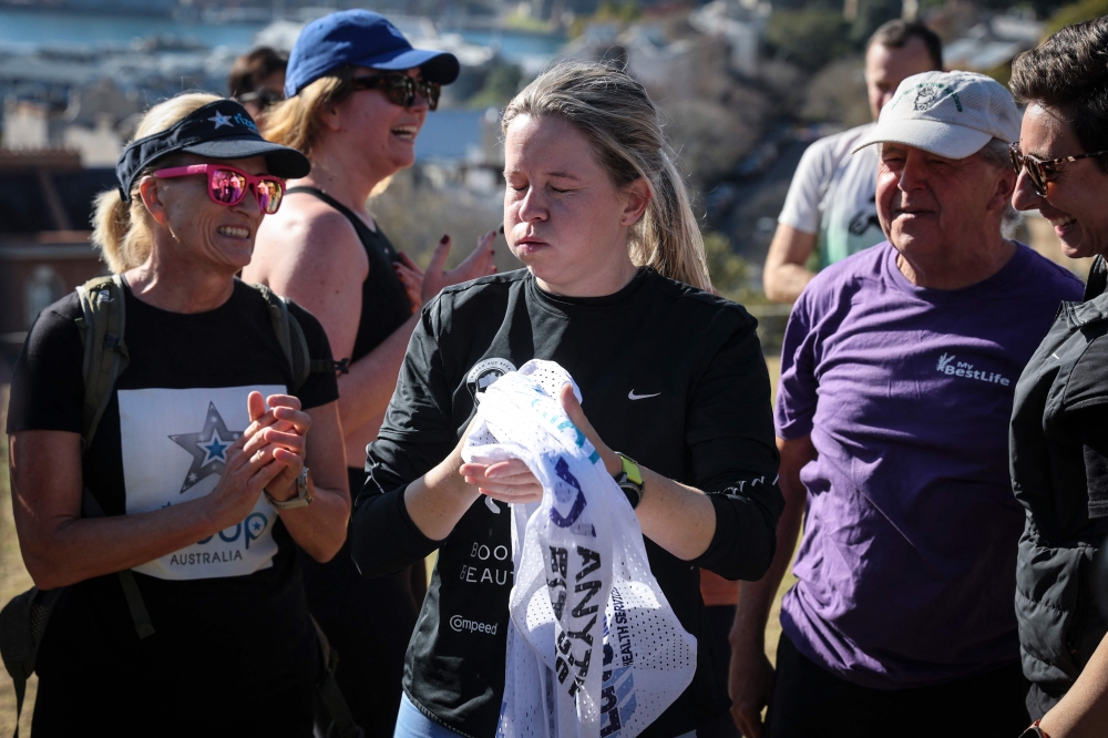 Former England footballer and ultra long-distance runner Fran Hurndall reacts as she is congratulated by supporters on June 29, 2025. (Photo by David Gray / AFP)