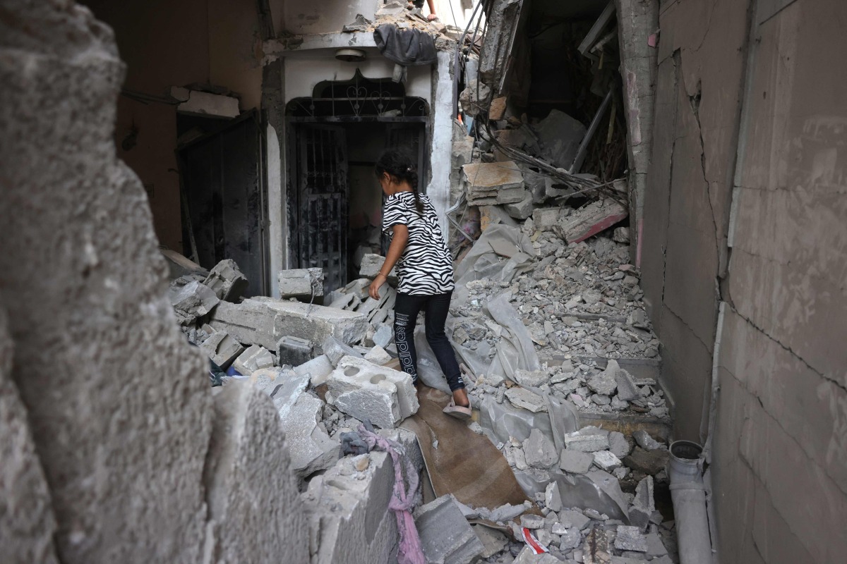 A Palestinian girl walks in the rubble of a building that was targeted in an Israeli strike in the Sheikh Radwan neighbourhood in Gaza City, in the central Gaza Strip on July 6, 2025. (Photo by Bashar TALEB / AFP)