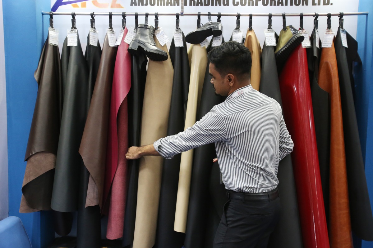 An exhibitor arranges leather products at the 9th edition of Bangladesh Leather and Footwear Expo in Dhaka, Bangladesh, on July 24, 2025. (Photo by Habibur Rahman/Xinhua)
