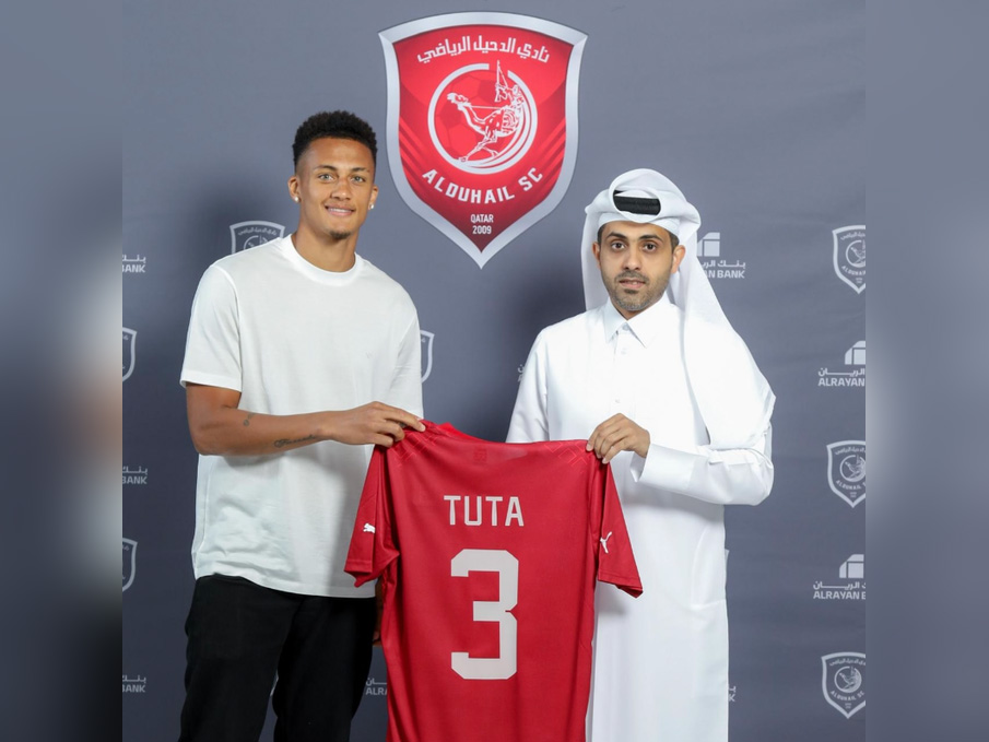 Tuta poses with an official.
