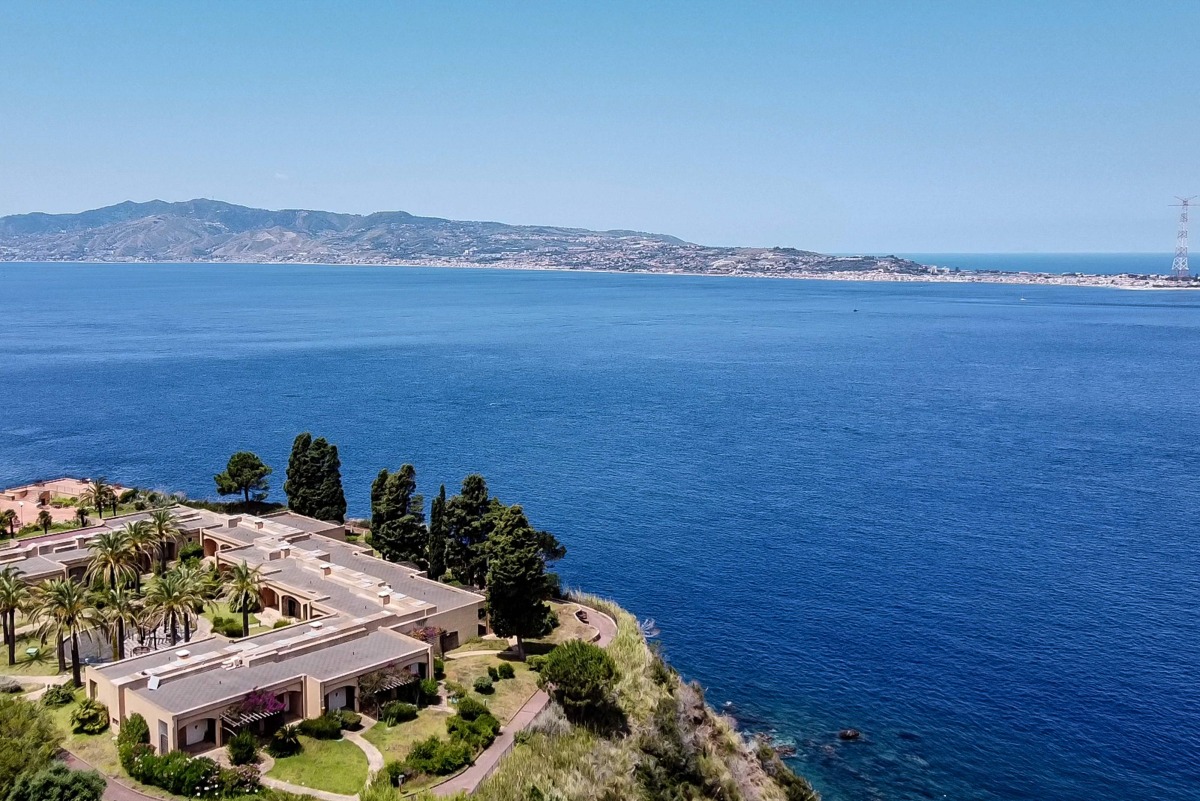 A general aerial view shows the Sicilian coast towards Cape Torre Faro, over the Strait of Messina, taken from the outskirts of the town of Scilla, in Calabria region in southern Italy, on July 7, 2020. Photo by Andreas SOLARO / AFP