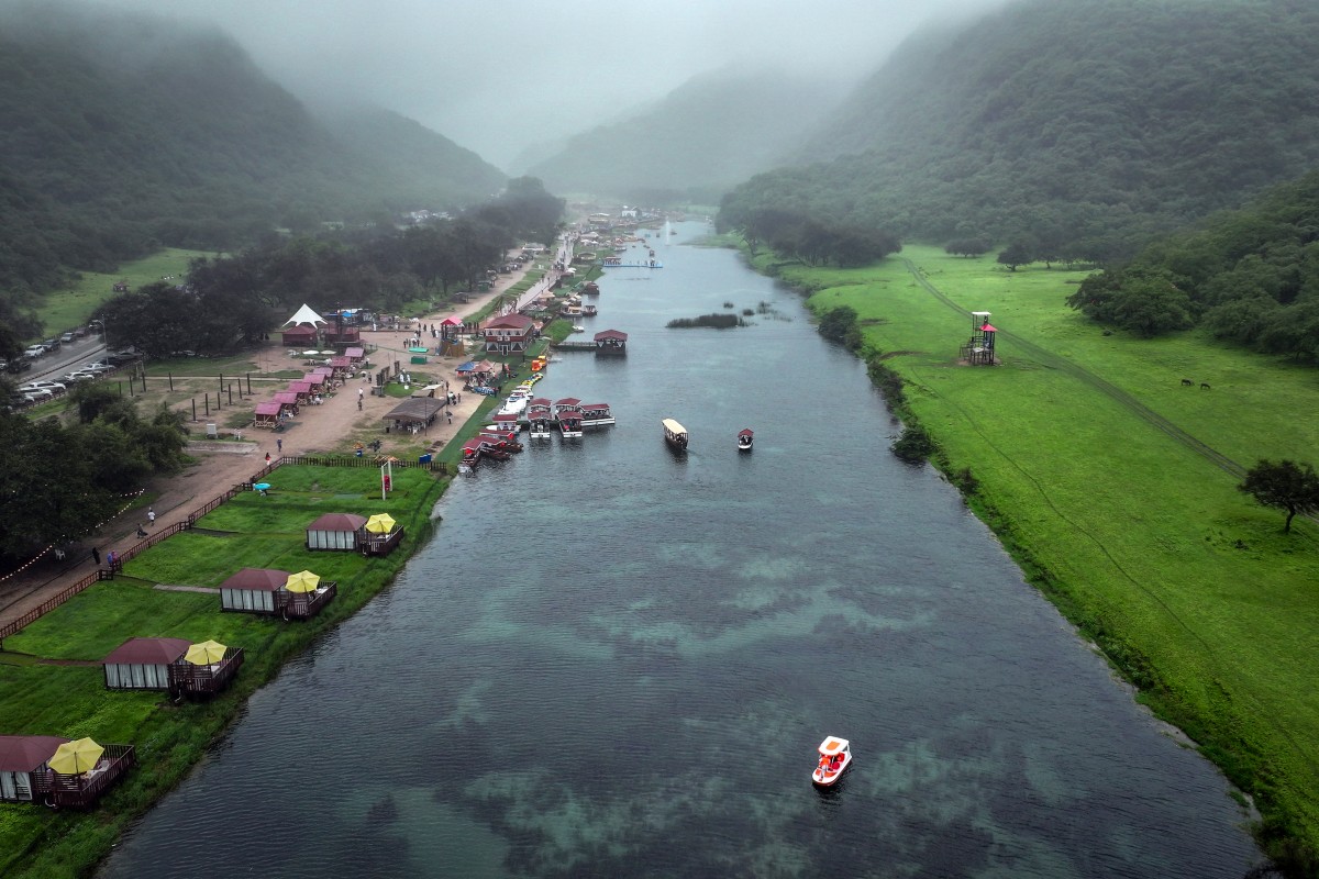 An aerial picture shows a touristic spot on the Wadi Darbat lake in the region of Dhofar, near Oman's Salalah city on July 25, 2025. (Photo by AFP)
