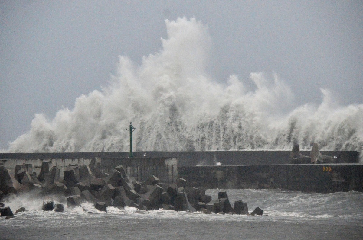 This picture taken and released by Taiwan's Central News Agency (CNA) on August 13, 2025 shows waves generated by Typhoon Podul breaking along the coast in Taitung.  Photo by CNA / AFP