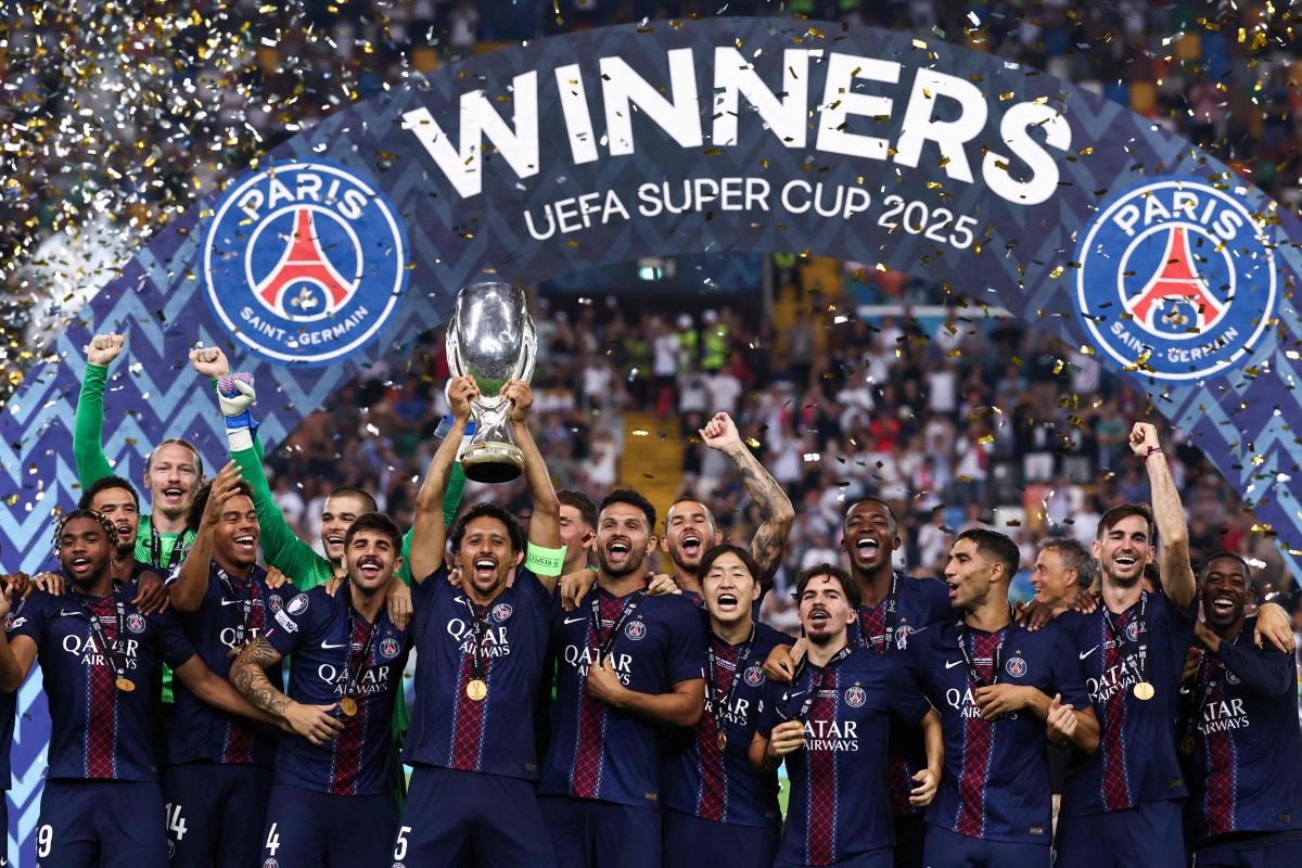 Paris Saint-Germain's Brazilian defender #05 Marquinhos lifts the trophy as Paris Saint-Germain celebrate winning the 2025 UEFA Super Cup final football match between Paris Saint-Germain (FRA) and Tottenham Hotspur FC (ENG) at the Friuli stadium, in Udine, on August 13, 2025. (Photo by FRANCK FIFE / AFP)
