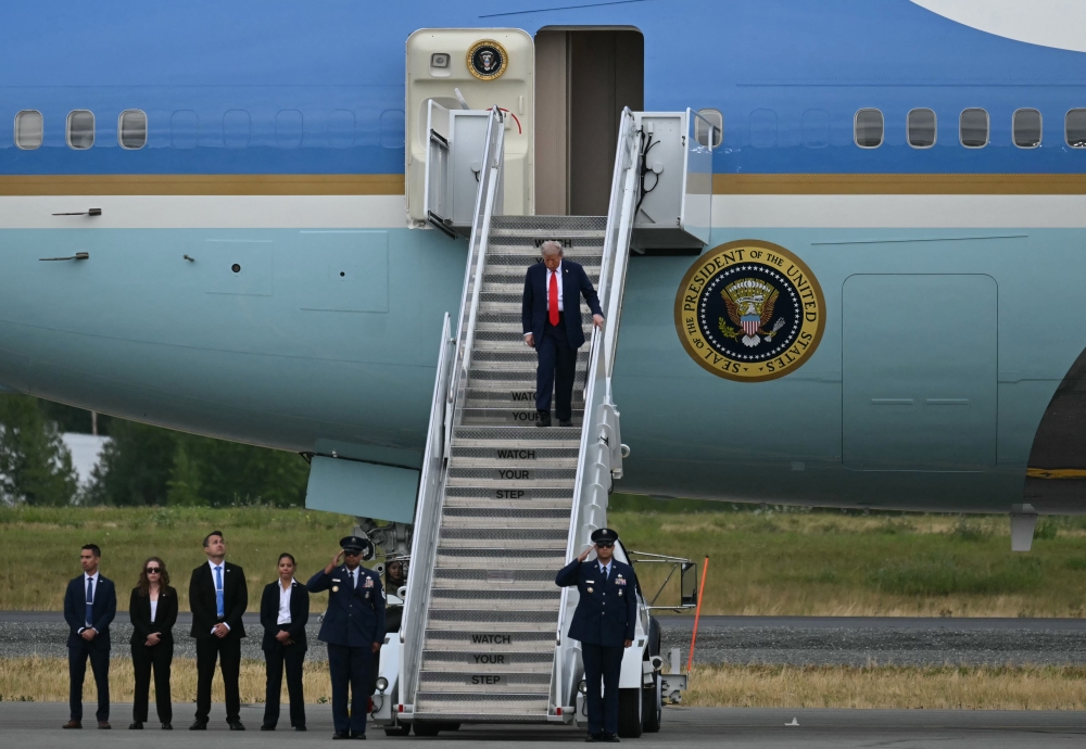 US President Donald Trump steps off of Air Force One upon arrival at Joint Base Elmendorf-Richardson in Anchorage, Alaska, on August 15, 2025.  (Photo by Andrew Caballero-Reynolds / AFP)
