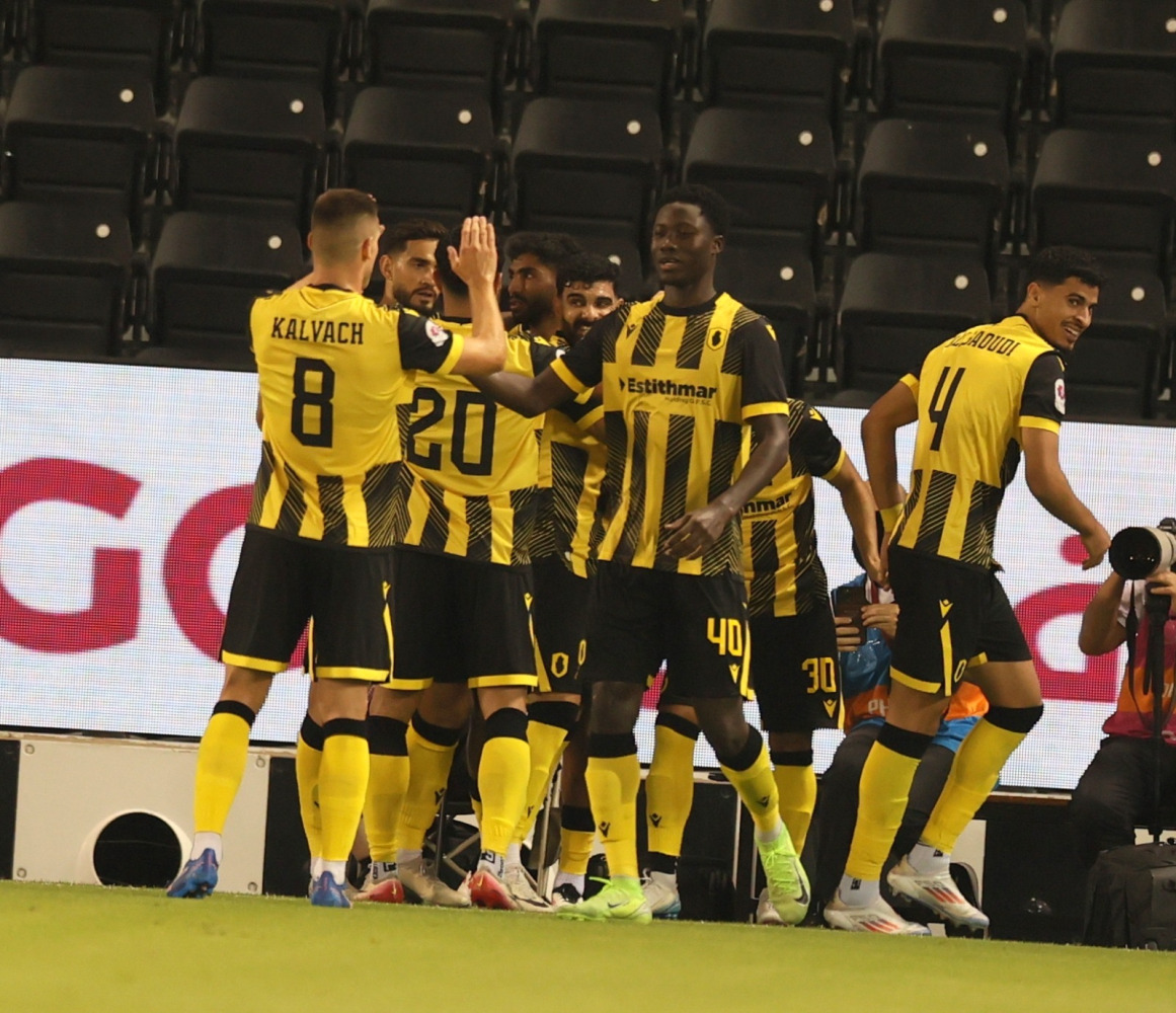Qatar SC players celebrate during their match against Al Sadd.