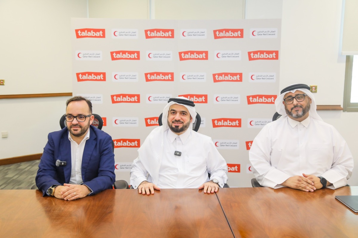 QRCS and talabat officials at an event.