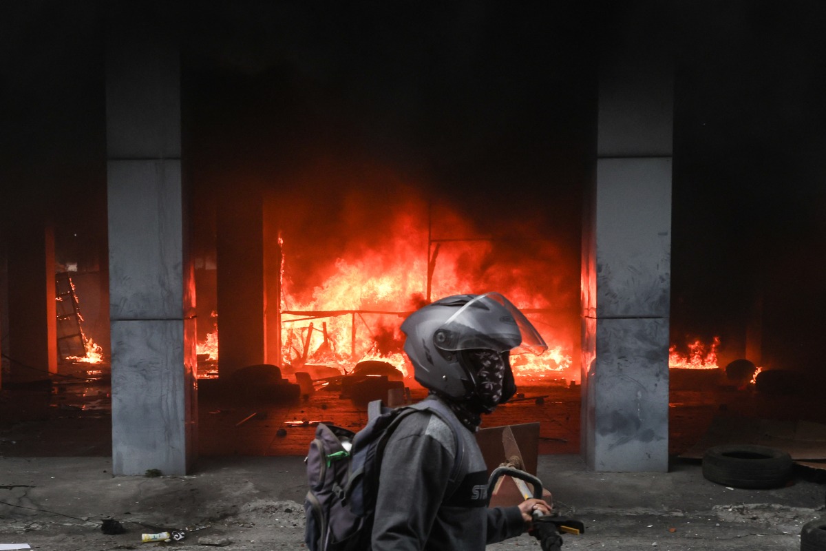The West Nusa Tenggara Provincial Council office is seen on fire after it was stormed and looted during a demonstration in Mataram on Lombok Island, West Nusa Tenggara, on August 30, 2025. Photo by AFP.