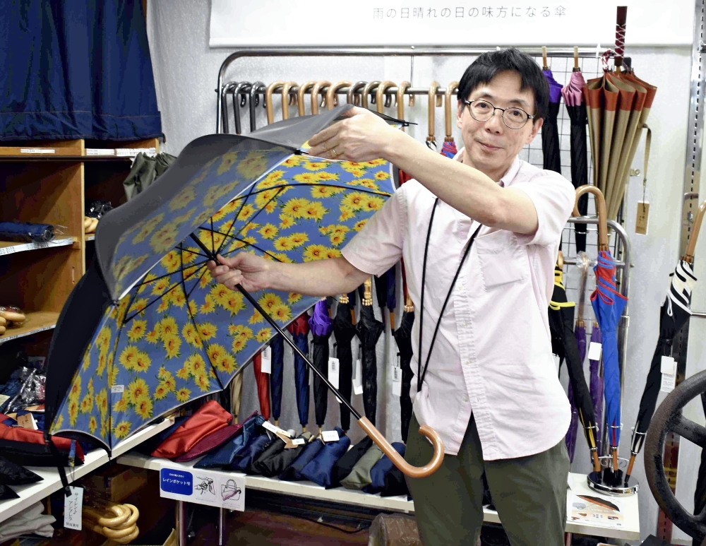 Hirofumi Kawaguchi shows a Silent Umbrella at Maruyasu Yougasa in Abeno Ward, Osaka. Pic: The Japan News
 