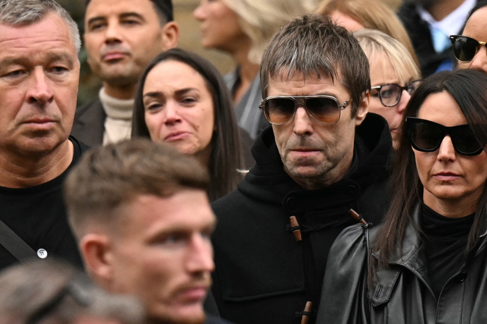Oasis frontman Liam Gallagher (2R) arrives to attend the funeral of late British boxer Ricky Hatton on October 10, 2025. (Photo by Oli SCARFF / AFP)