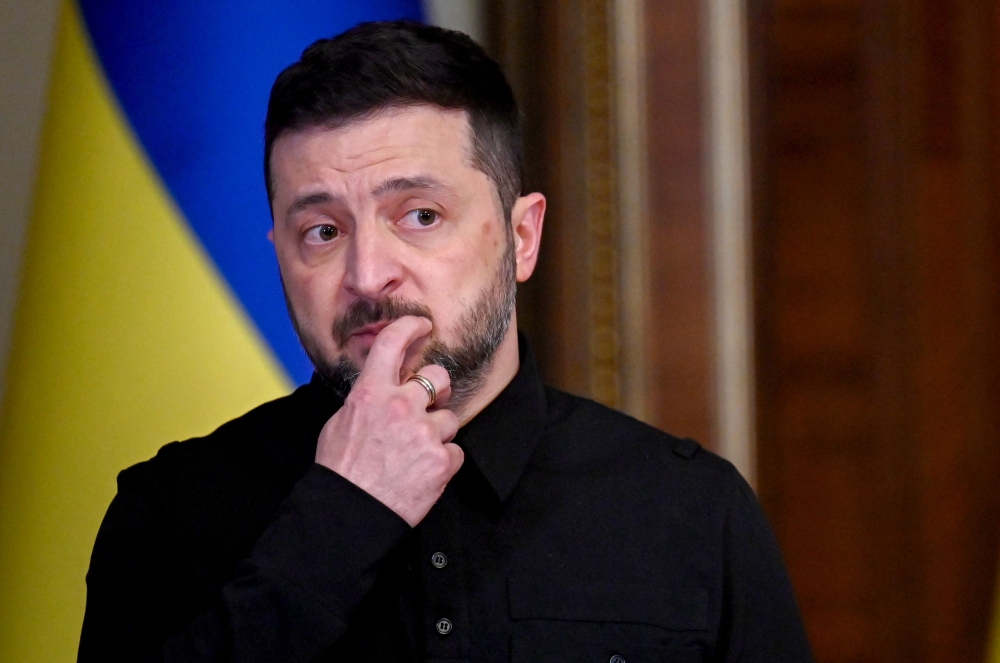 Ukraine's President Volodymyr Zelensky reacts as he holds a joint press-conference following talks with High Representative of the European Union for Foreign Affairs and Security Policy in Kyiv on October 13, 2025, amid the Russian invasion in Ukraine.(Photo by Sergei Supinsky / AFP)