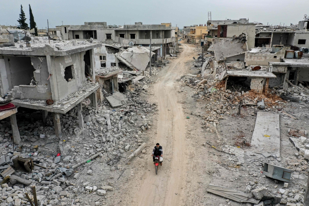 File: This picture taken on March 12, 2020 shows an aerial view of the town of Afis, which has sustained widespread destruction due to heavy fighting and air-strikes by pro-Syrian regime forces, in the northwestern Idlib province. (Photo by Omar Haj Kadour / AFP

