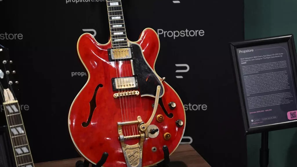 The cherry-red Gibson ES-355 guitar is famous for having been damaged during a fight that led to the Oasis band breaking up in August 2009. (Justin Tallis / AFP)