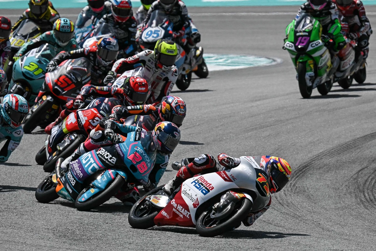 Riders compete in the Moto3 race at the MotoGP Malaysian Grand Prix at the Sepang International Circuit in Sepang on October 26, 2025. (Photo by Lillian SUWANRUMPHA / AFP)