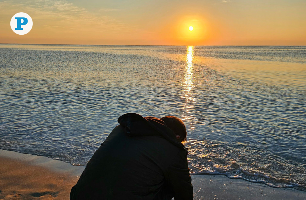 A man captures the rising sun over Sealine in Mesaieed, as morning temperatures cool across Qatar. Photo by Marivie Alabanza / The Peninsula