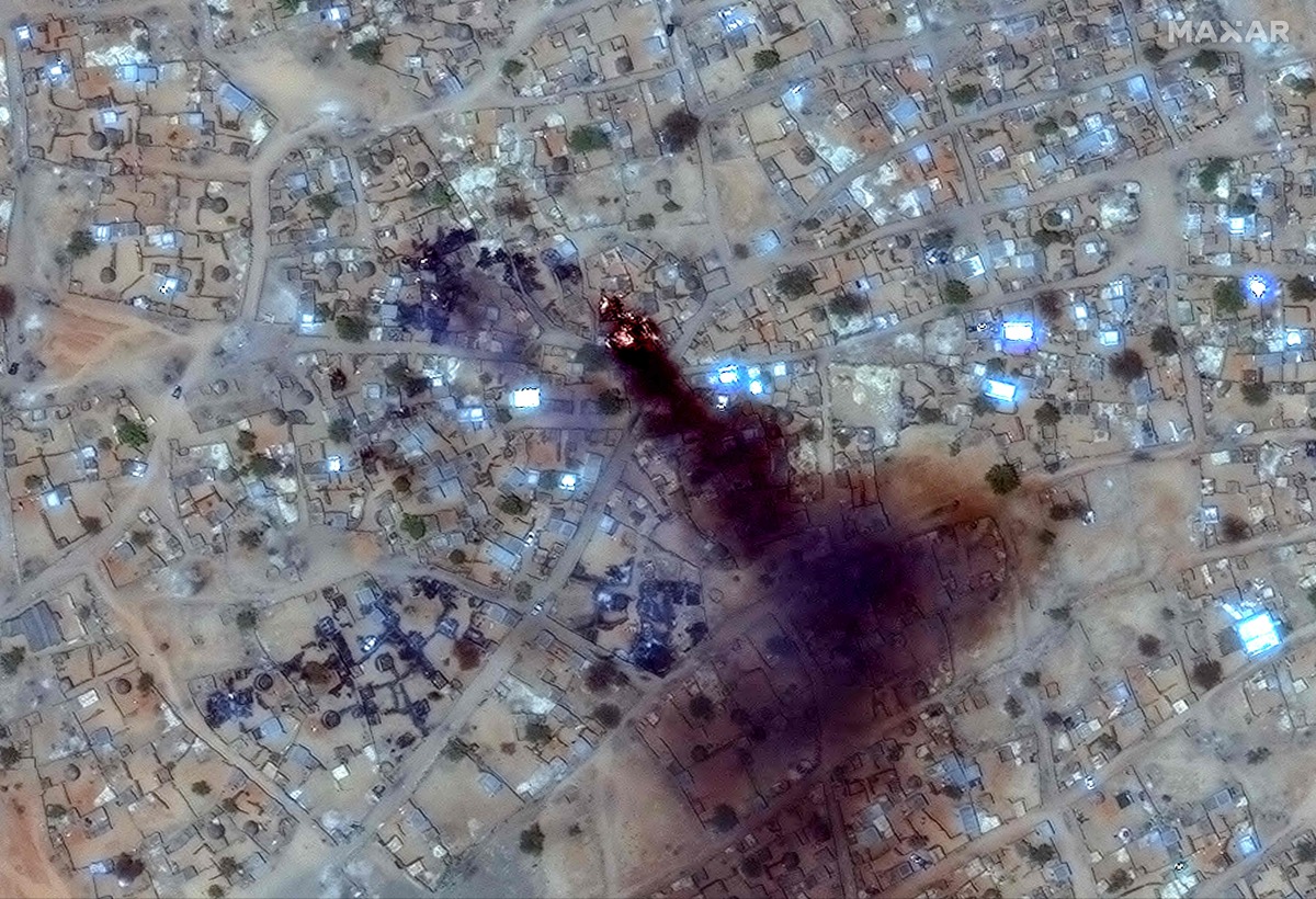 (FILES) This handout image courtesy of Maxar Technologies taken on April 16, 2025 and released on April 17, 2025, shows fire and smoke at Zamzam camp near the besieged Darfur city of El-Fasher. (Photo by Satellite image 2025 Maxar Technologies / AFP)