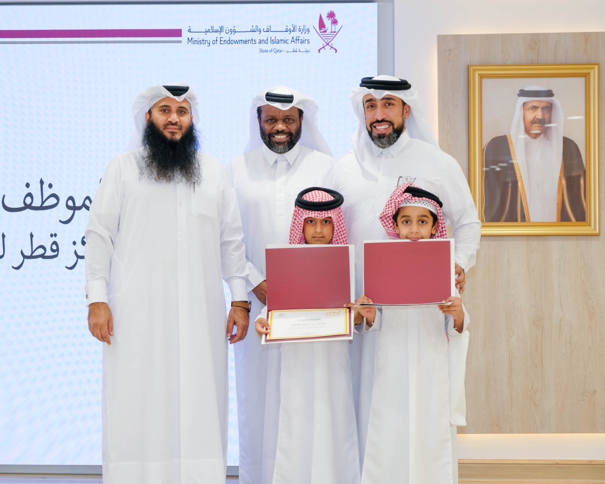 Officials with participating children during the event.