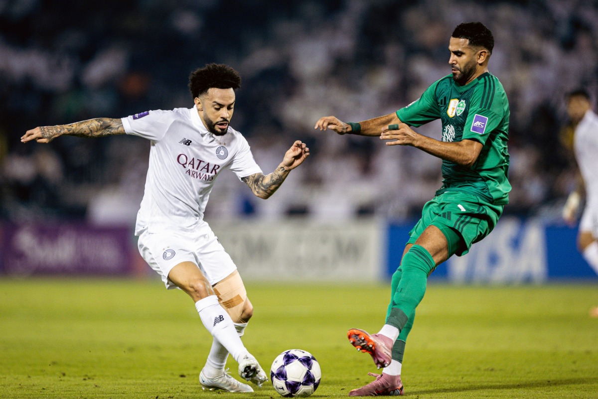 Al Sadd's Claudinho (left) vies for the ball with Al Ahli Saudi FC's Riyad Mahrez.
