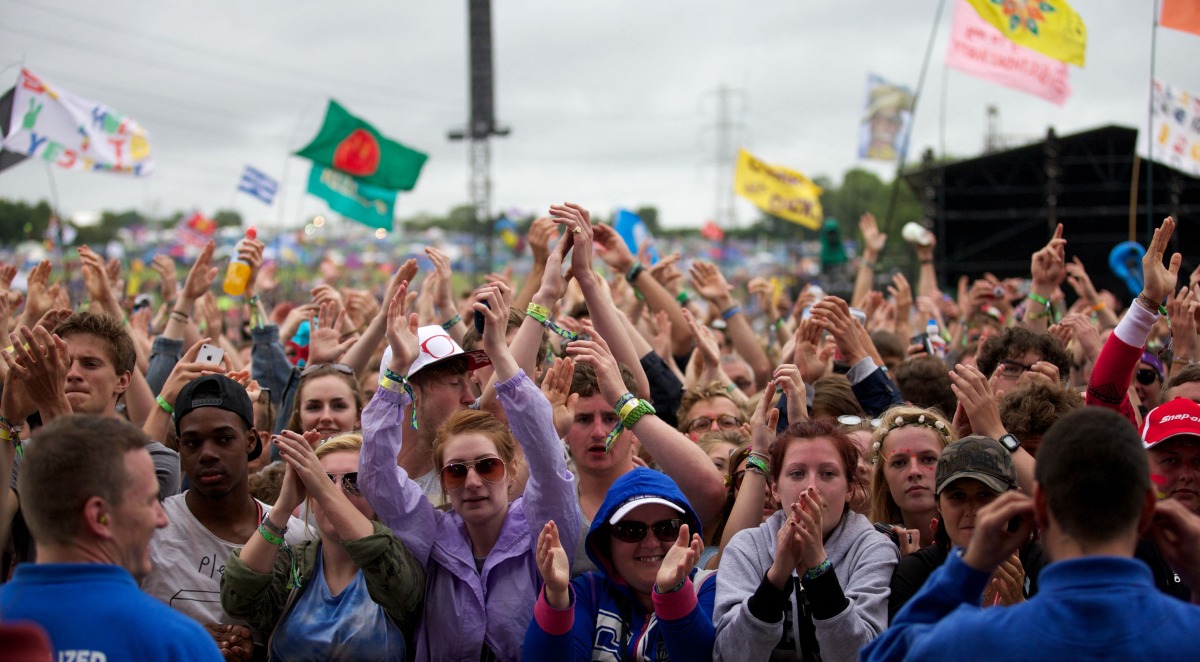 Festival goers attend concerts at the Pyramid Stage during the third day of the Glastonbury Festival of Contemporary Performing Arts near Glastonbury, southwest England, on June 28, 2013. Photo by ANDREW COWIE / AFP