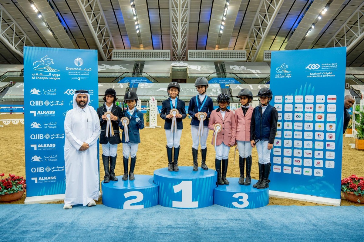 Al Shaqab’s Event Director Mohamed Jaber Al Khayareen poses with young riders on the opening day.
