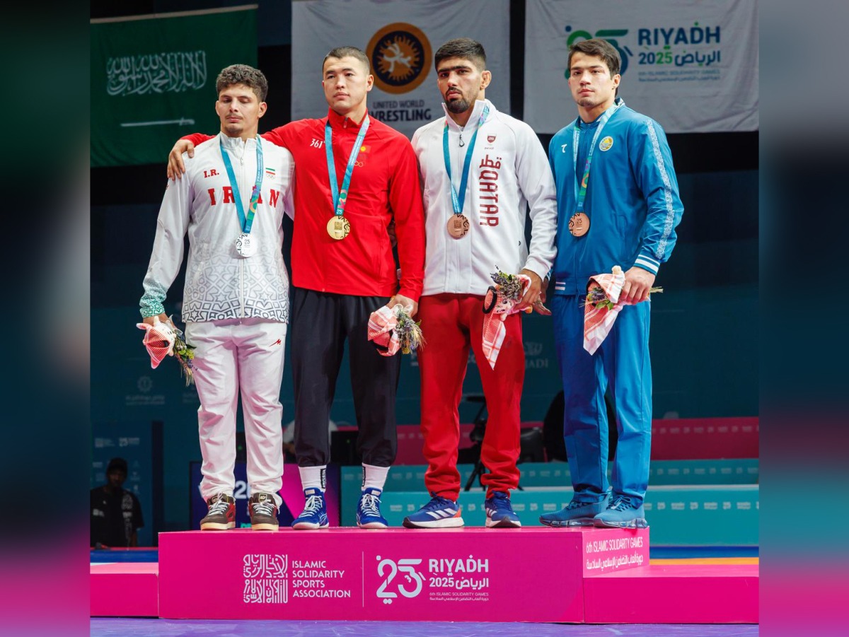 Qatar's Shaheen Mohammad (third left) with the podium winners of the men's 77kg wrestling event.