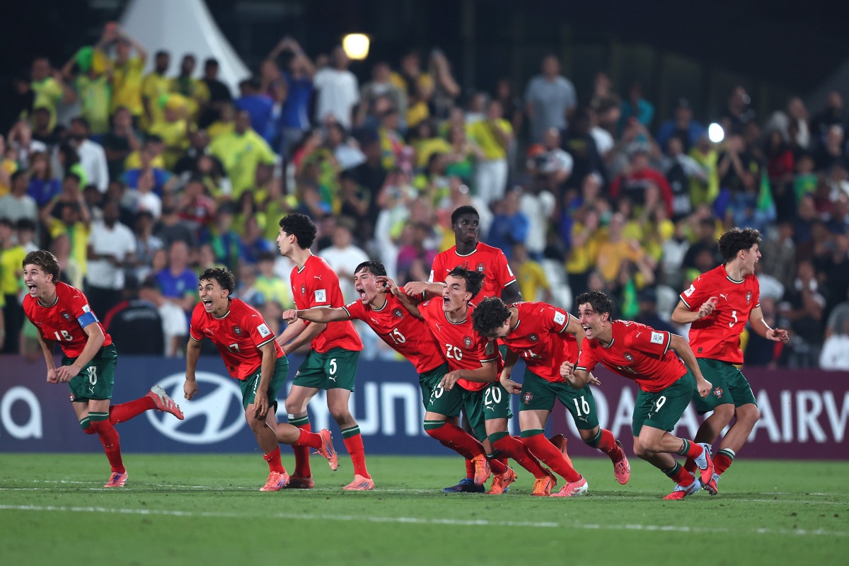 Portugal players celebrate after winning the penalty shoot out against Brazil.
