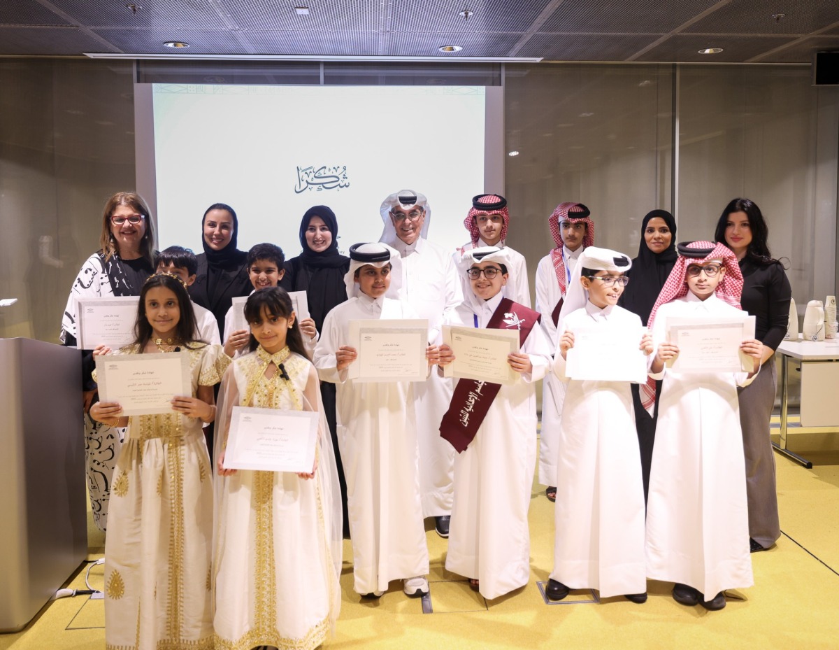 Minister of State and President of Qatar National Library H E Dr. Hamad bin Abdulaziz Al-Kawari and other officials with winners of the competition