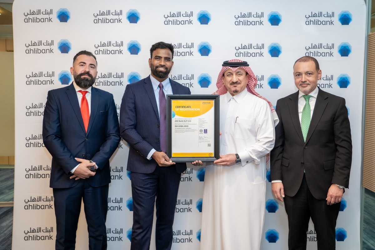 Ahlibank official receiving the ISO certification.