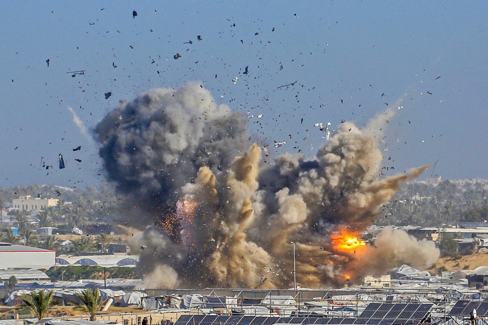 Smoke rises from the Gath shelter, housing displaced Palestinians, after an Israeli air strike in the west of Khan Yunis, southern Gaza Strip on January 31, 2026. (Photo by Bashar Taleb / AFP)