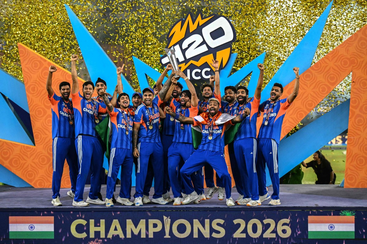 Indian players celebrate with the trophy after winning the 2026 ICC Men's T20 cricket World Cup final match against New Zealand at the Narendra Modi Stadium in Ahmedabad on March 8, 2026. (Photo by Punit PARANJPE / AFP)