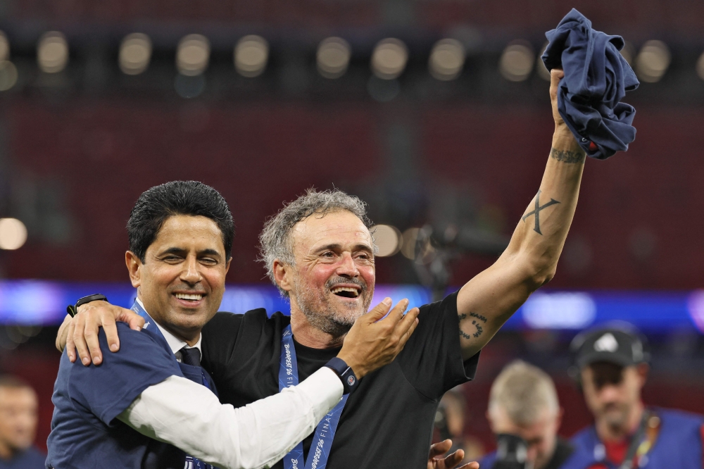 Paris Saint Germain's Qatari president Nasser al-Khelaifi (L) and Paris Saint-Germain's Spanish head coach Luis Enrique celebrate winning the UEFA Champions League final football match between Paris Saint-Germain (PSG) and Arsenal FC at the Puskas Arena in Budapest on May 30, 2026. (Photo by Odd Andersen/ AFP)