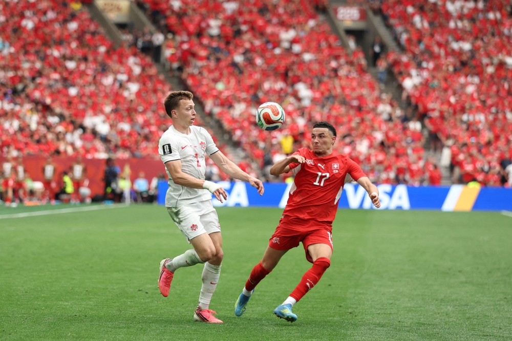 Alistair Johnston #2 of Canada and Ruben Vargas #17 of Switzerland compete for the ball on June 24, 2026 in Vancouver, British Columbia. Emilee Chinn/Getty Images/AFP