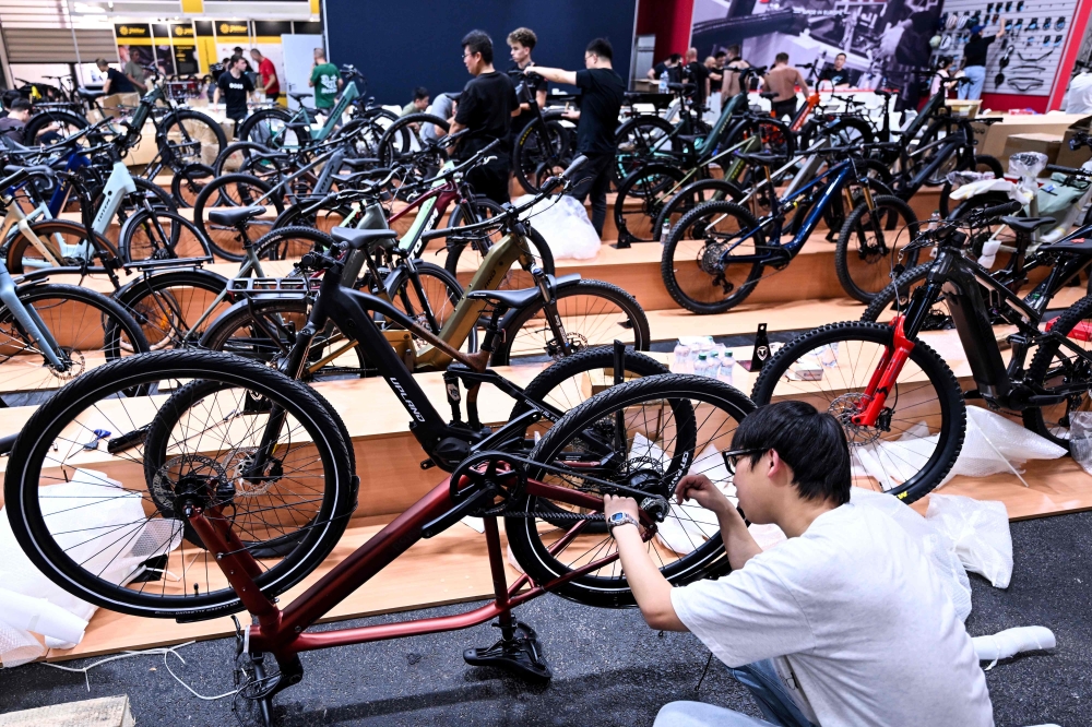 An employee prepares a booth at the EUROBIKE 2026 fair of the international bicycle industry in Frankfurt am Main, western Germany on June 23, 2026. (Photo by Kirill Kudryavtsev / AFP)