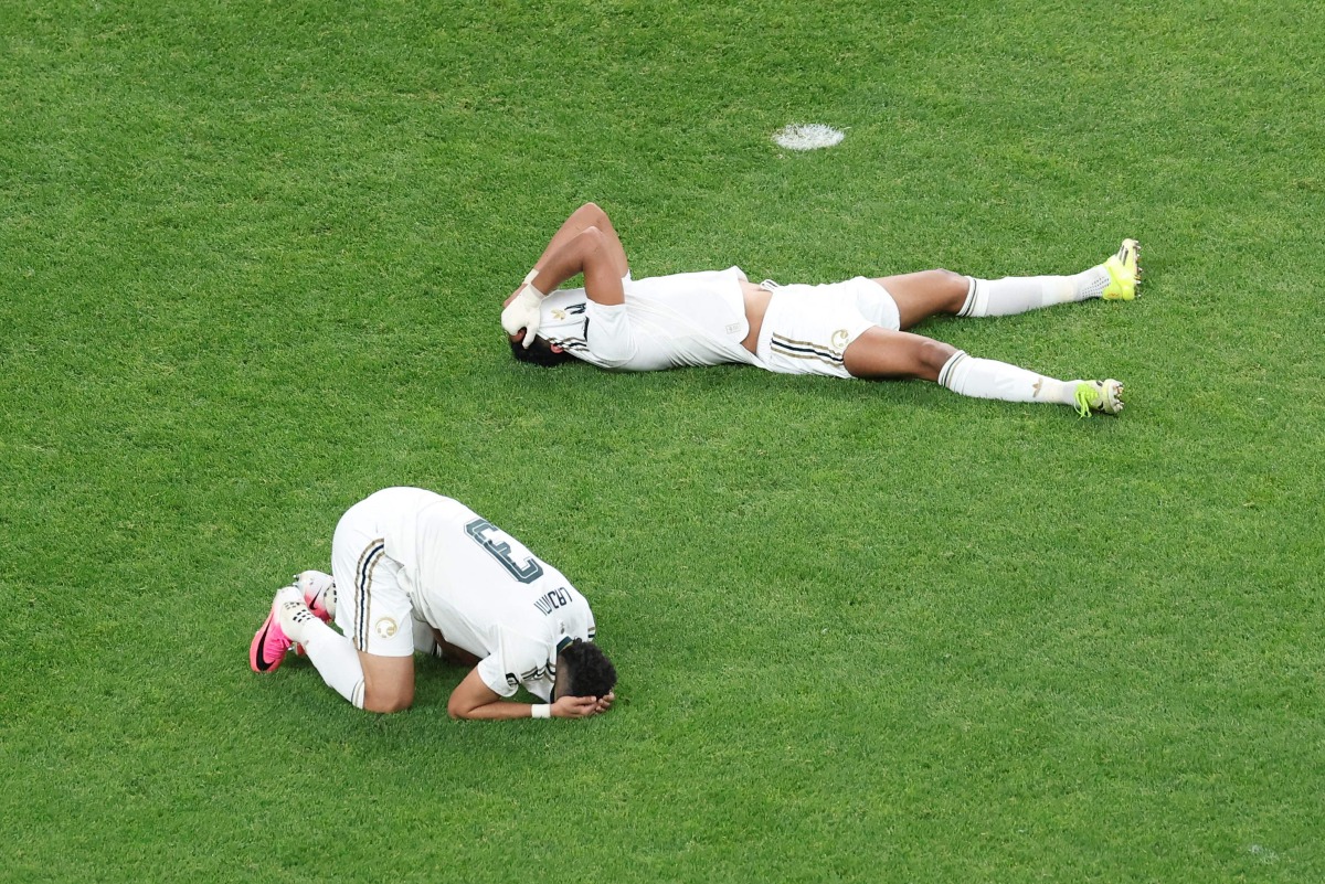 Saudi Arabia's Abdulelah Al-Amri and Ali Lajami react after being eliminated following the 0-0 draw with Cape Verde.