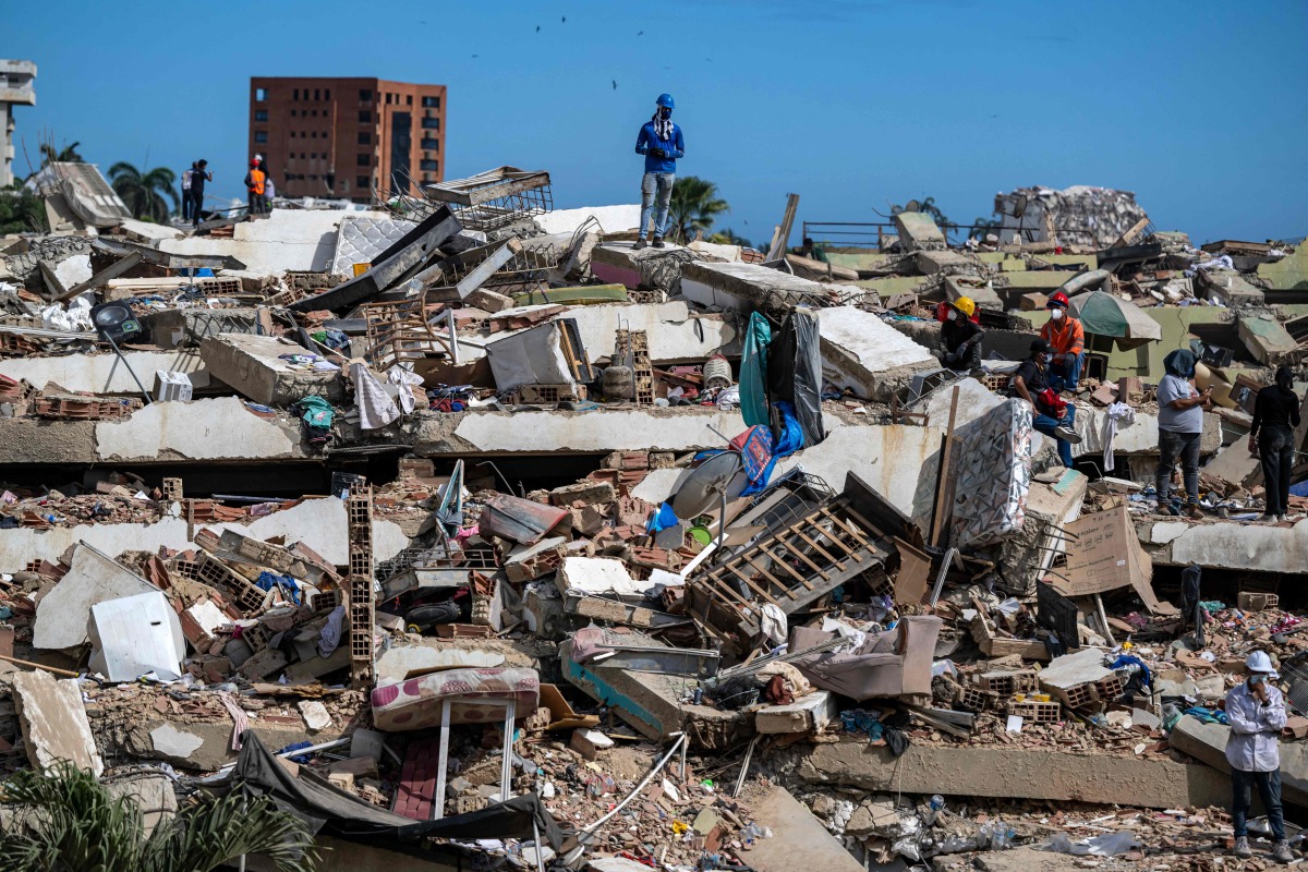 Volunteers and residents search for survivors on the rubble of collapsed buildings in Caraballeda, La Guaira state, Venezuela, on June 28, 2026, following earthquakes. Photo by Miguel MEDINA / POOL / AFP
